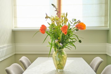 Bouquet of spring summer flowers and red poppies in vase