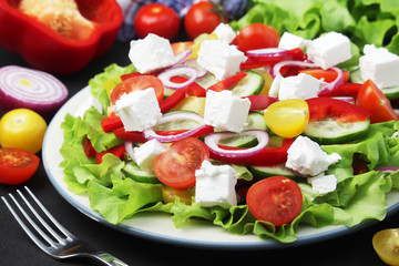 A plate full of bright fresh vegetable salad	