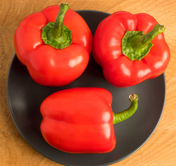 Red pepper in a plate on a wooden board