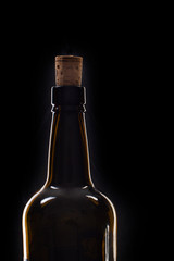 Closeup of an opening of a wine bottle with cork in front of black background with text field
