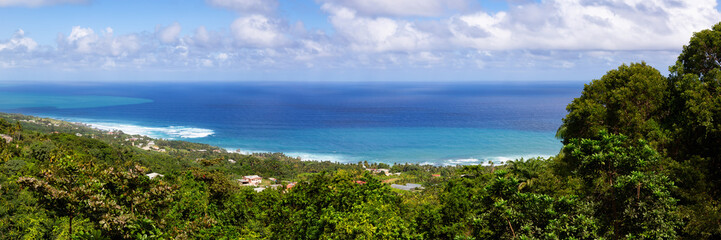 Fototapeta na wymiar Beautiful Panoramic View of the Caribbean Sea from top of a hill during a sunny and cloudy day. Church View, Saint John, Barbados.