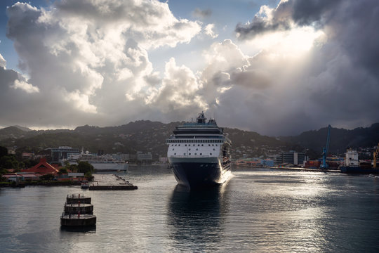Castries, Saint Lucia. View of a Big Luxurious Cruise Ships docked in a port during a cloudy and colorful morning sunrise.
