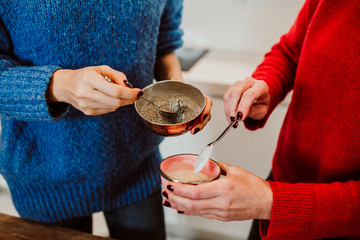 .A red haired middle-aged woman and a blondie young woman cook healthy food together to stay fit and be in good healht. Having great time. Lifestyle. Close up