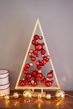 Alternative wooden christmas tree. A handmade Christmas tree and red christmas balls.