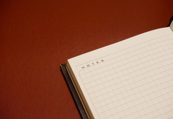 open notebook on brown background