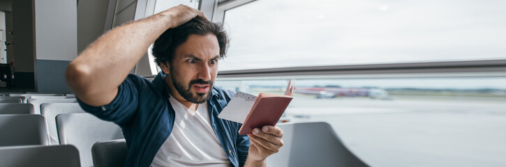The man is very upset in the waiting room at the gate to the airport.
