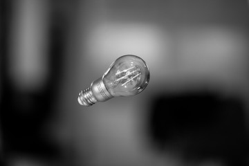 Levitating light bulb in black and white