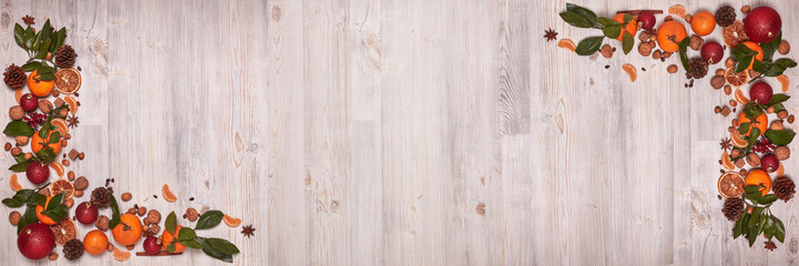 Christmas and New Year background with mandarins, nuts, spice and fir ornaments. Extra wide panorama banner background