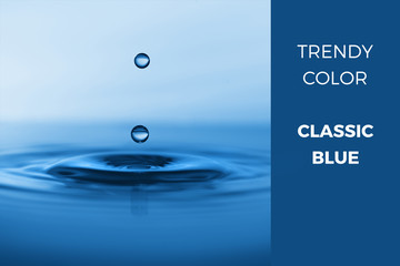Classic bluie - trendy color for 2020, toned macro image of drops falling into calm water with...