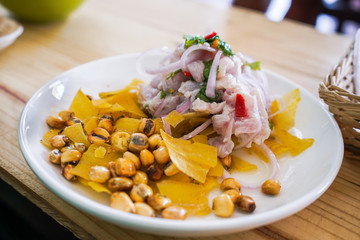 peruvian seafood with fish, fried bananas, onions and corn. Ceviche