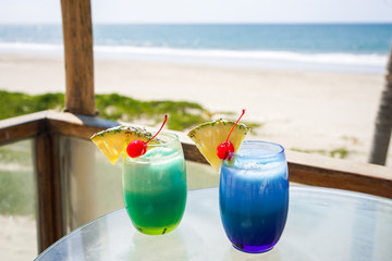 cocktails with cherry and pineapple on the beach
