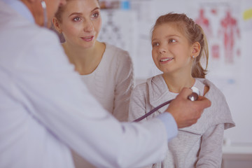 Girl and doctor with stethoscope listening to heartbeat