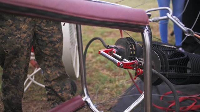 Adventure on hot air balloon watermelon. Burner directing flame into envelope and cold air by ventilating fan blower. Hot air burning gas fire to air balloon or aerostat during flight.