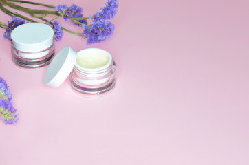 The concept of natural cosmetics with organic extract, essential oils, cream, serum for skin care, anti-aging, anti-wrinkle, moisturizing. spa treatments on a pink background. copy space