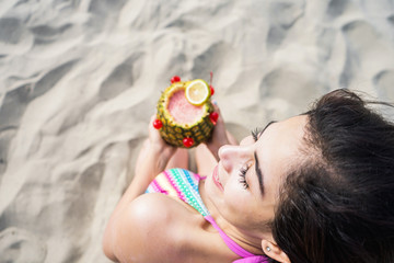 woman in the beach share  a pineapple