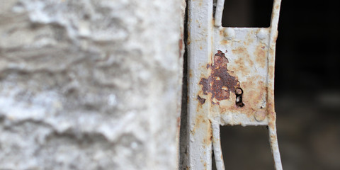 Closeup of old rusty metal lock and keyhole on a old iron door as a beautiful vintage background. Fragment of old rusty gate.