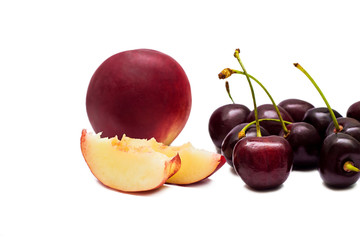 Juicy nectarine and ripe sweet cherries isolated on white background