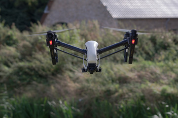 Drone flying in the air with the landing gear raised and without a camera attached to the drone