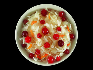 Homemade sauerkraut with cranberries in white bowl top view isolated on black background  