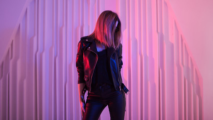 Beautiful girl dancing in retro wave on the neon light