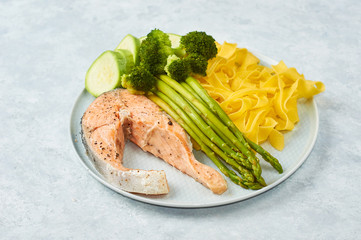 Healthy food, steamed salmon, with steamed vegetables. Eggplant, broccoli, asparagus.