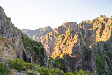 Fototapeta premium Sunset in picturesque mountainous landscape in Portuguese island Madeira on route to highest peaks between Pico Ruivo and Achada do Teixeira. 
