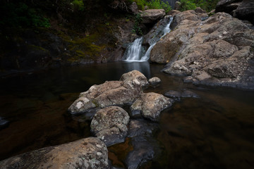Nature around Lagoa do Vento and Risco waterfalls in Rabacal valley, Paul da Serra plateau, Madeira, Portugal. Smooth water around rocks in the stream, long shutter speed photo.