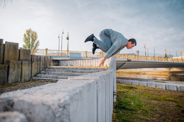Sportive man in action while jump over obstacles