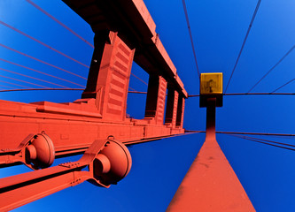 Daytime view up at tower and Lighting for the Golden Gate Bridge 