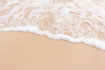 Fototapeta na wymiar Soft smooth waves on the beach.