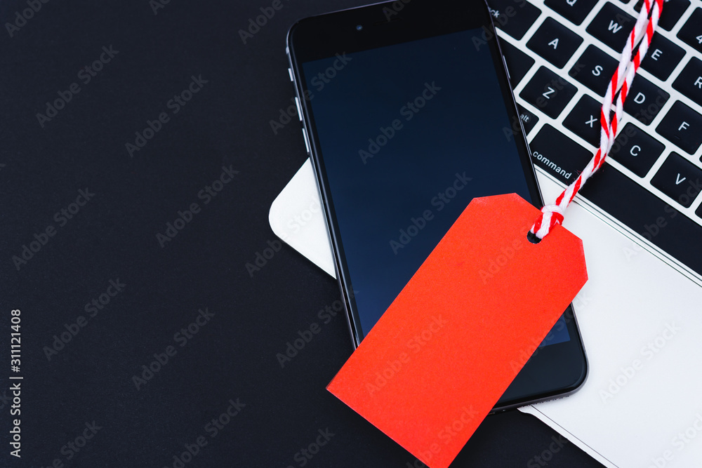 Poster blank red tag have mobile smart phone over laptop computer