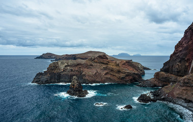 The sunrise panorama on the trekking trail in the eastern-most peninsula of Portuguese island Madeira, Sao Lourenco Point (locally known as Vereda da Ponta de Sao Lourenco). Vertical basalt cliffs.