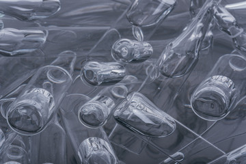 Glass medical ampoule vial for injection. Medicine is liquid sodium chloride with of aqueous solution in ampulla. Close up. Bottles ampule multicolor on background color and water. Human plasma.