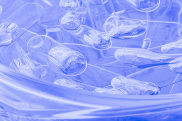 Glass medical ampoule vial for injection. Medicine is liquid sodium chloride with of aqueous solution in ampulla. Close up. Bottles ampule multicolor on background color and water. Human plasma.