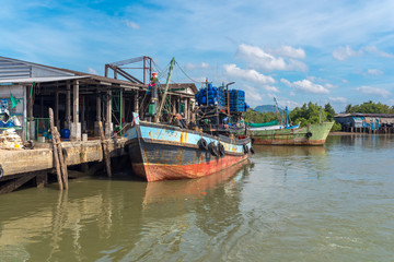 Fishing trawler is moored at the pier in the industrial estate of the Ranong fishing harbor in the...