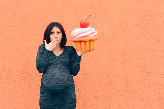 Pregnant Woman Craving Sweets Holding Huge Cupcake