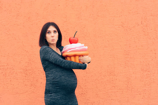 Pregnant Woman Craving Sweets Holding Huge Cupcake