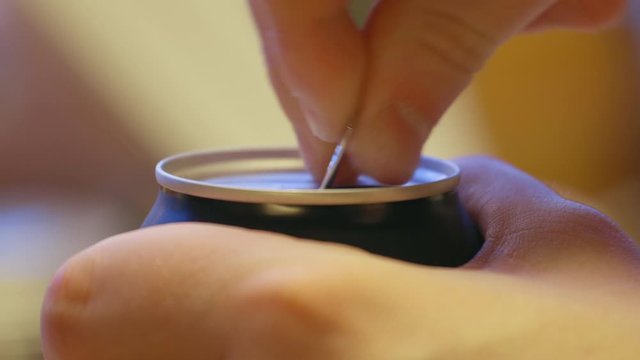 Opening a soda can with fingers