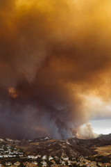 Vertical shot of California wildfire threatening a residential area