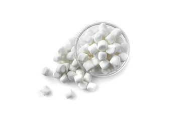 Small white marshmallows in a glass bowl on white background