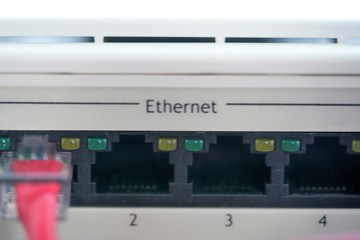 closeup of ethernet ports on plastic panel of network router