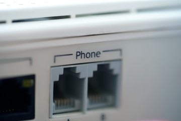 closeup of two phone ports on plastic panel of network router