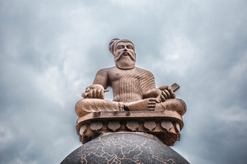 Thiruvaluvar Statue close up sitting on a Globe, Mahabalipuram, India 2018