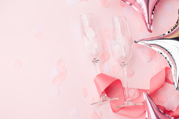 wineglasses on a pink background. Background for holiday, birthday, wedding, Valentine's day, Women's Day party. Top view, flat lay composition. Copy space for design.