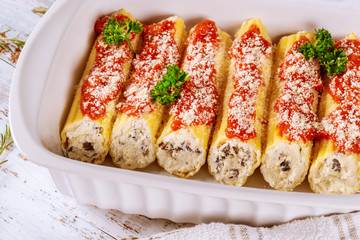 Cannelloni stuffed with ricotta cheese, meat and tomato pasta.