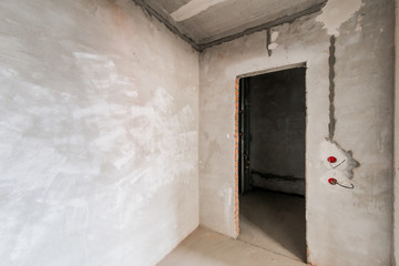 Russia, Omsk- August 05, 2019: interior room apartment. standard repair decoration in hostel. rough repair for self-finishing. interior decoration, bare walls of the room, stage of construction