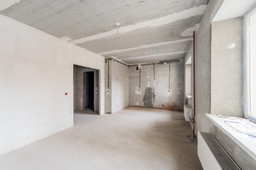 Russia, Omsk- August 05, 2019: interior room apartment. standard repair decoration in hostel. rough repair for self-finishing. interior decoration, bare walls of the room, stage of construction
