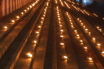 line of oil lamps placed on steps forming a pattern, low light photography Arulmigu Kapaleeswarar Temple mylapore chennai tamilnadu india
