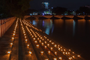 line of oil lamps placed on steps forming a pattern, low light photography Arulmigu Kapaleeswarar Temple mylapore chennai tamilnadu india