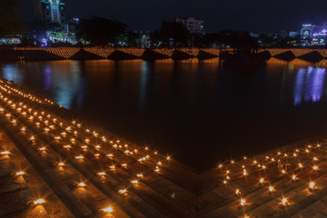line of oil lamps placed on steps forming a pattern, low light photography Arulmigu Kapaleeswarar Temple mylapore chennai tamilnadu india